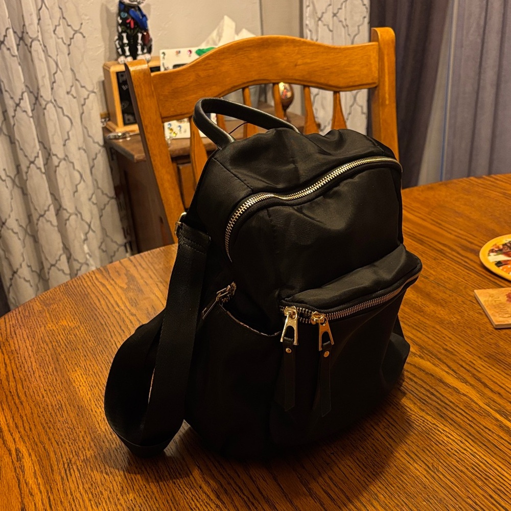 Stylish Black Backpack with Silver Zippers